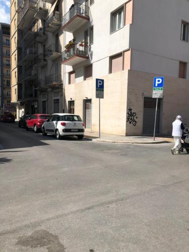 a parking lot with cars parked next to a building at Rosabella Casa Vacanze in Bari