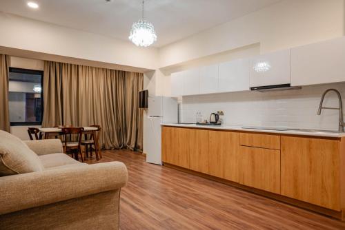 a kitchen and living room with a couch and a table at Bakuriani Inn in Bakuriani