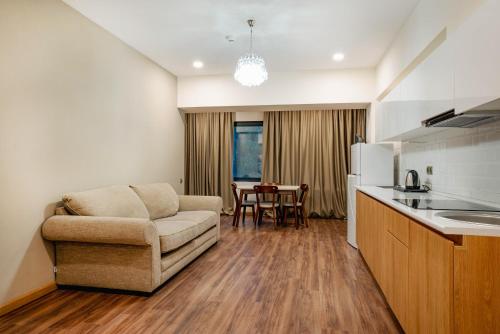 a kitchen and living room with a couch and a table at Bakuriani Inn in Bakuriani