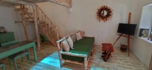 a room with a chair and a table and stairs at Aliori art caves in Aegiali