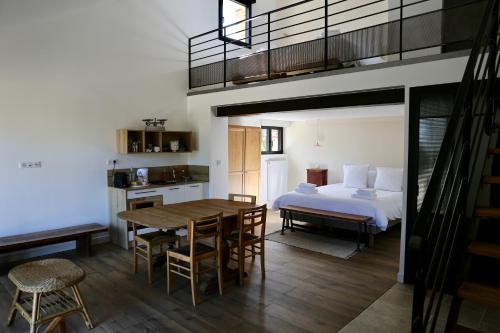 a bedroom with a bed and a table and chairs at La Grange du Veld in Téteghem