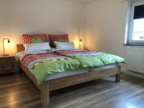 uma cama com duas almofadas e um cobertor em Waldmomente em Schauren