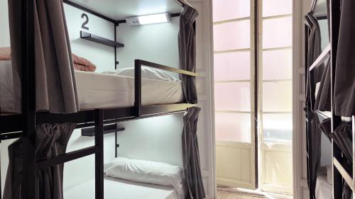 a room with bunk beds and a window at Way Hostel Madrid in Madrid