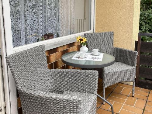 a small table and chairs on a balcony at Ferienwohnung Dittmar am Kaffeehof in Bad Liebenzell