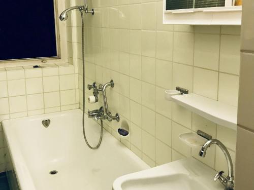 a bathroom with a shower and a tub and a sink at Ferienwohnung Dittmar am Kaffeehof in Bad Liebenzell