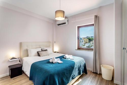 a bedroom with a bed with two towels on it at #164 Saradel 42 by Home Holidays in Albufeira