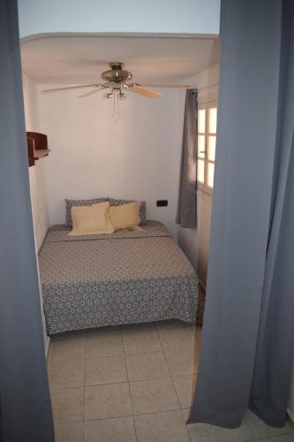 a bedroom with a bed and a ceiling fan at Duplex con vistas mijas Golf in Mijas