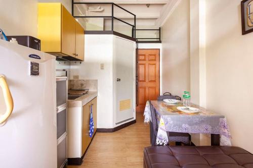 a small kitchen with a small table in a room at Casa Jessica 326 Heavens Place One bedroom plus loft Condo Unit in Bacoor