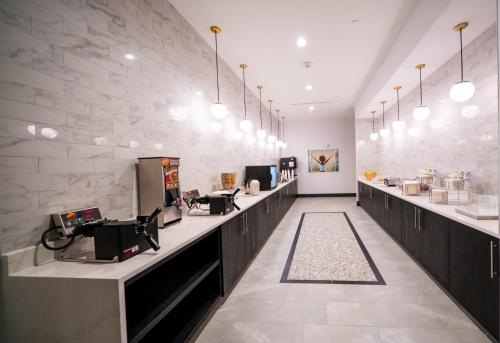 a hair salon with a row of sinks and mirrors at La Quinta Inn & Suites by Wyndham Austin Parmer Tech Ridge in Austin