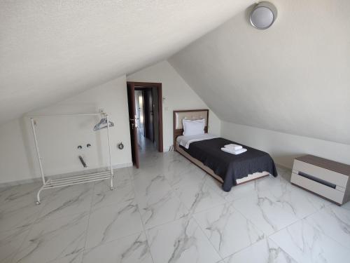 a bedroom with a bed and a shower in it at VILLA CASSIOPEIA in Nikiti
