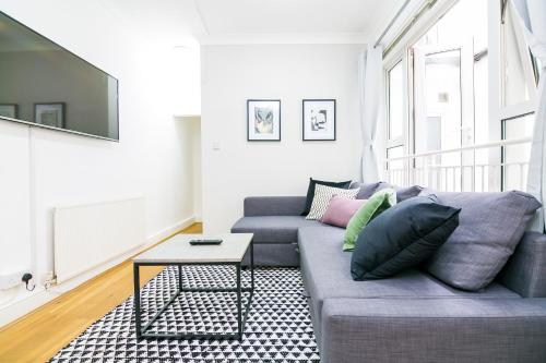 a living room with a couch and a table at Chancery Lane Residences in London