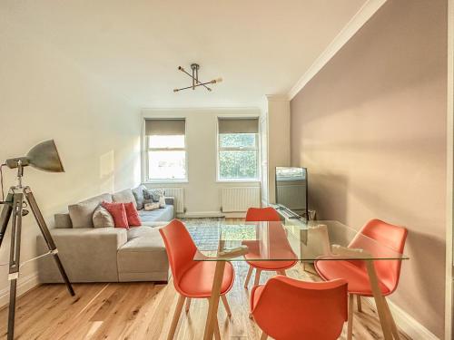 a living room with a table and chairs and a couch at Chancery Lane Residences in London