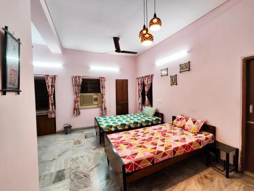 a room with two beds and a couch at Spacious 3BHK House opp South City Mall in Kolkata