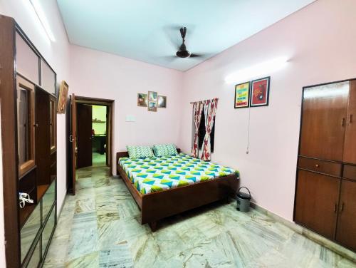 a bedroom with a bed in a room at Spacious 3BHK House opp South City Mall in Kolkata