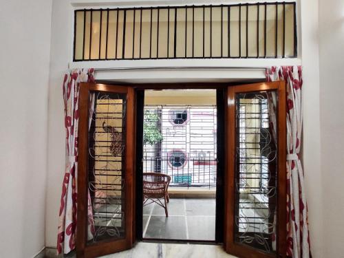 an open door to a room with a window at Spacious 3BHK House opp South City Mall in Kolkata