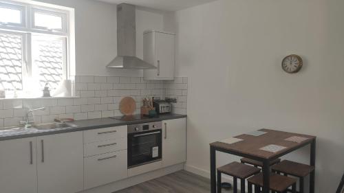 a kitchen with a sink and a stove top oven at Stunning One Bedroom Holiday Flat In Weymouth in Weymouth