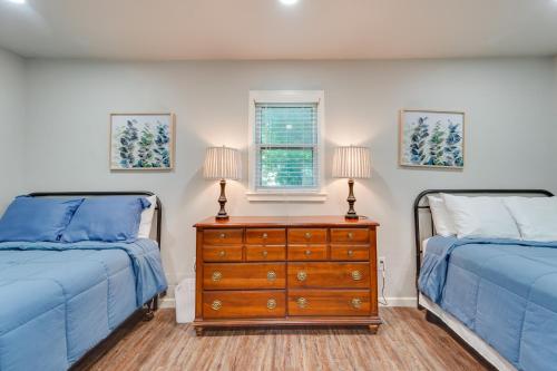 a bedroom with two beds and a dresser with two lamps at Amarillo Vacation Rental with Shared Pool! in Amarillo