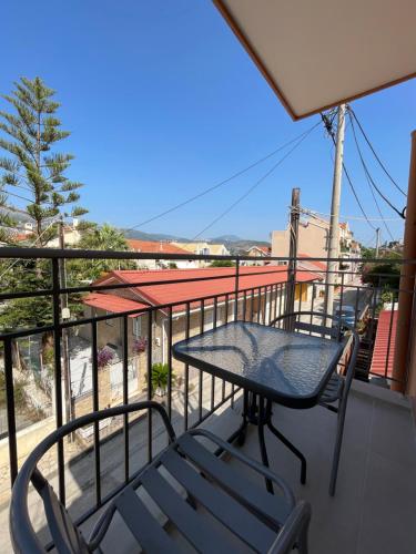 a patio table and chairs on a balcony at Arian Apartments in Argostoli