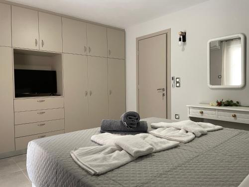 a bedroom with a bed with towels on it at Arian Apartments in Argostoli