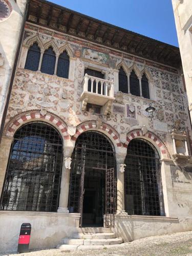 a large stone building with three large windows at b&b casa largo la piazzola in Vittorio Veneto