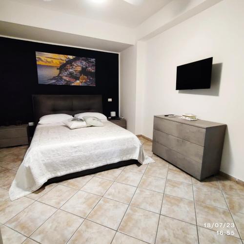 a bedroom with a bed and a flat screen tv at Casa Coppola in Santa Maria La Carità