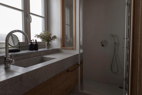 a bathroom with a sink and a shower at enδόtera chios apartments in Chios