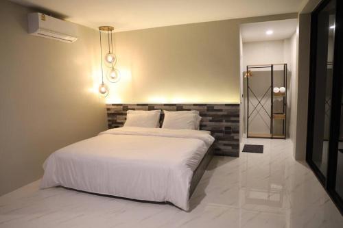 1 dormitorio con cama blanca y espejo en Million Stars Poolvilla en Wang Nam Khieo