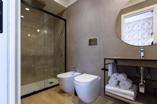 a bathroom with a shower and a toilet and a sink at Le Gemme di Cavour Luxury Rooms in Palermo