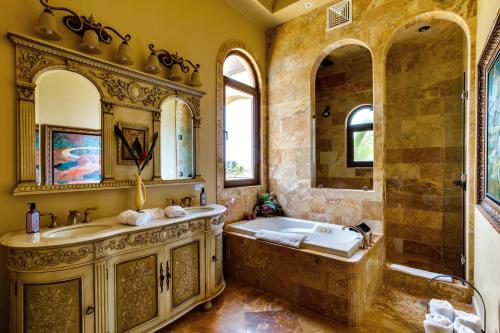 a large bathroom with a tub and a sink at Villa Castello- Water Views & Resort Amenities in Placencia
