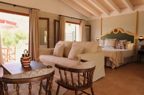 a living room with a couch and a bed at Llucatx Menorca in Son Parc