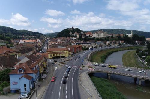 a city with a bridge and cars on a road at Panorama Studio Sighisoara in Sighişoara