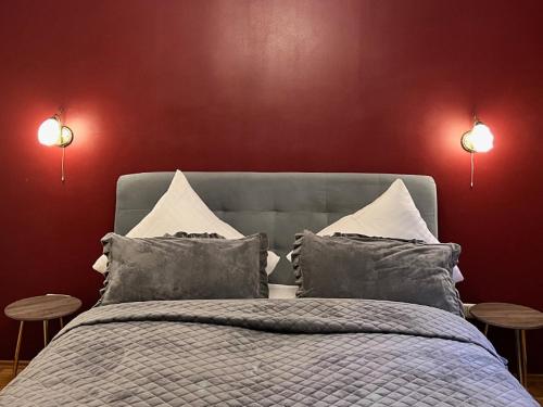 a bedroom with a large bed with two tables at Hotel Neuhauser in Volkach