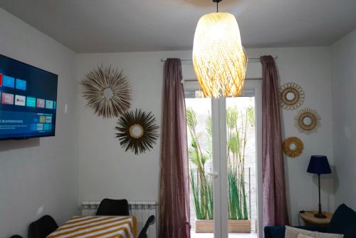 a chandelier hanging over a window in a room at Casa Galdós in Logroño