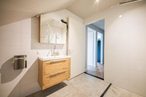a bathroom with a sink and a mirror at Beloved 3 Bedroom Apartment in Rotterdam