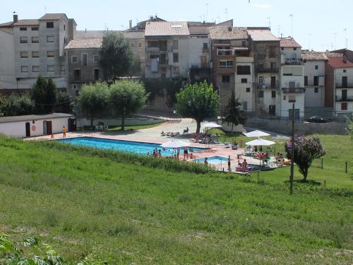 a view of a swimming pool with buildings in the background at La Llar de Peramola in Peramola