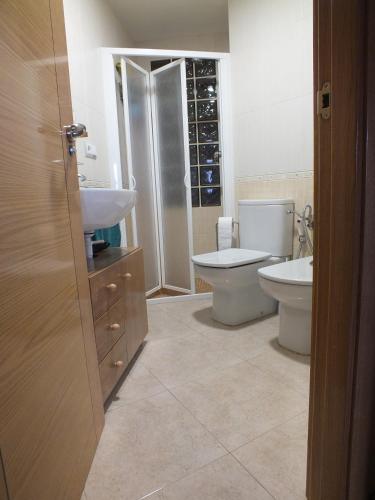a bathroom with a toilet and a sink at La Llar de Peramola in Peramola