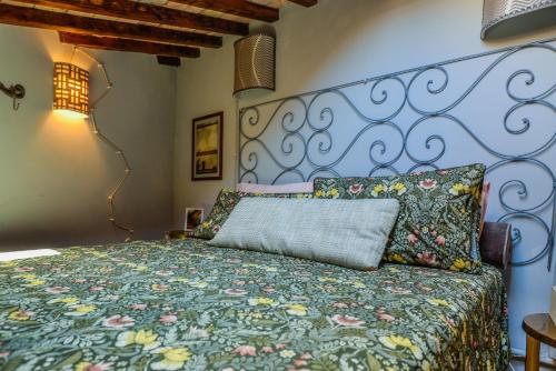 a bedroom with a bed with a colorful bedspread at La Torretta in Torrita Tiberina