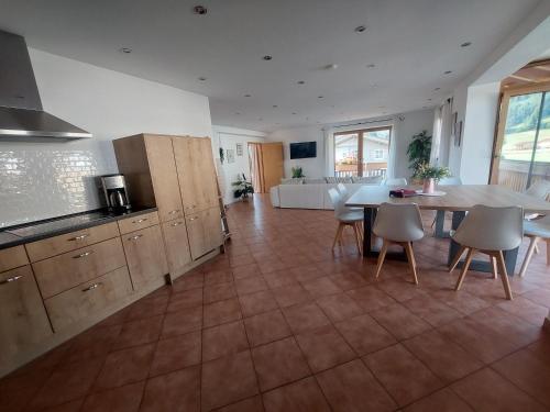a kitchen and dining room with a table and chairs at Apartment Traumblick in Unterammergau