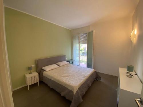 a small bedroom with a bed and a window at Appartamento Pirandello in Lido di Camaiore