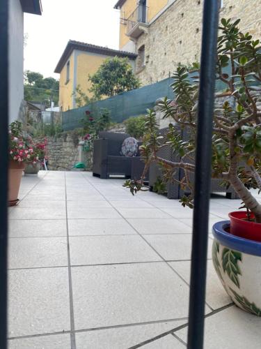 a walkway with plants and benches in a building at B&B La Panoramica in Castelmezzano