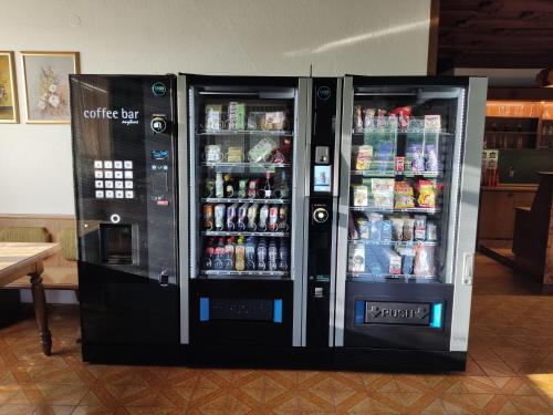 two soda machines are standing next to each other at Die Sonnenblume in Sankt Kanzian