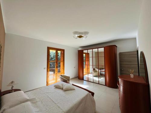 a bedroom with a bed and a large window at Casa Manila in Avola