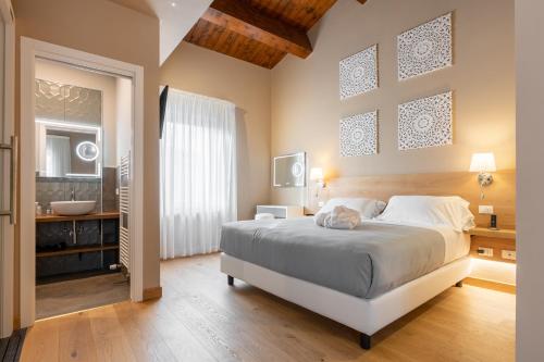 a bedroom with a large bed and a bathroom at GG8 Hotel & Suite SPA in Gualdo Tadino