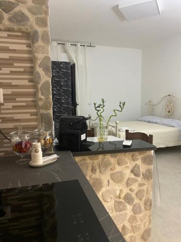 a kitchen with a counter top and a bed in a room at B&B La Panoramica in Castelmezzano