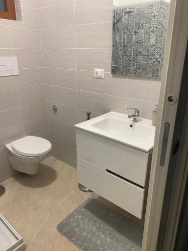 a bathroom with a white sink and a toilet at B&B La Panoramica in Castelmezzano