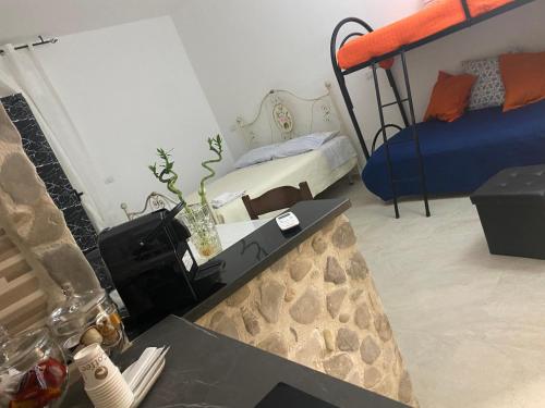 a room with two bunk beds and a table at B&B La Panoramica in Castelmezzano