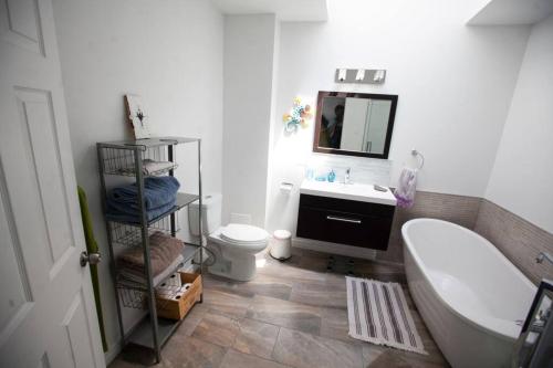 a bathroom with a sink and a toilet and a mirror at Bel Grand app.-Plateau Mont-Royal-No-CITQ 298319 in Montréal