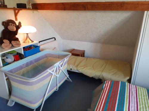 Dormitorio pequeño con cama y cuna en Le petit chemin, en Bougival