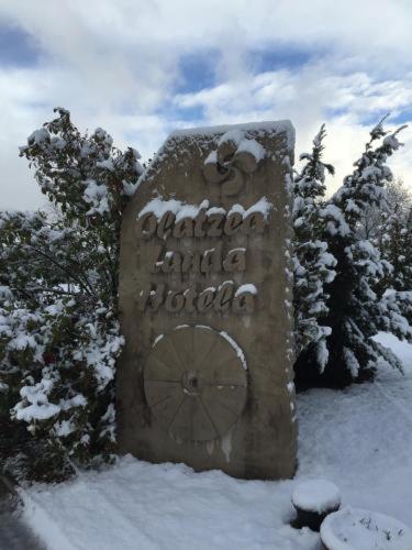 a stone sign with snow on top of it at OLATZEA LANDA HOTELA in Arbizu