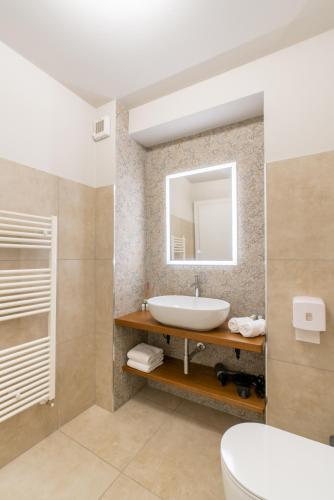 a bathroom with a sink and a mirror at GG8 Hotel & Suite SPA in Gualdo Tadino